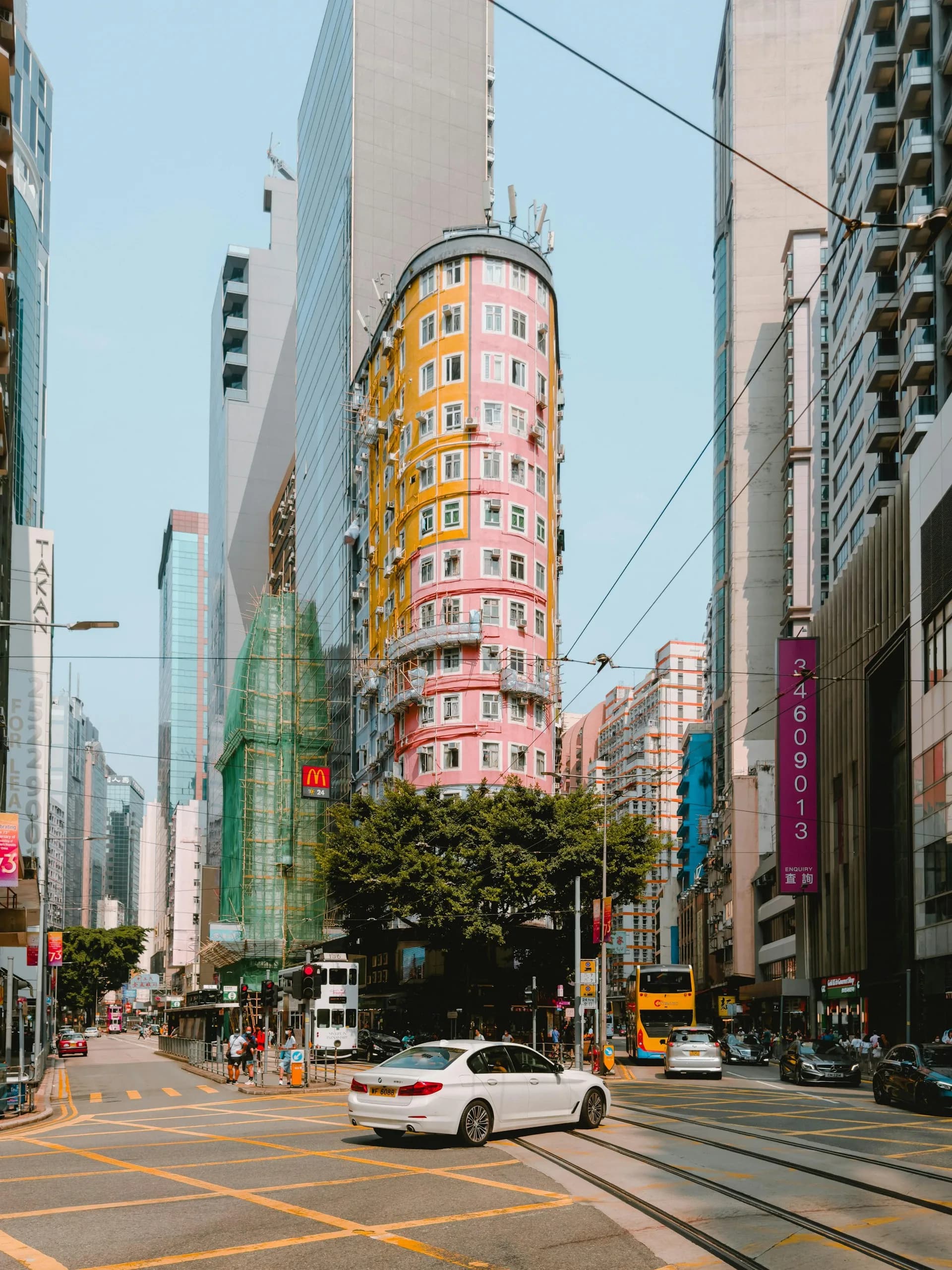 Wan Chai street with tram lines and Hong Kong towers