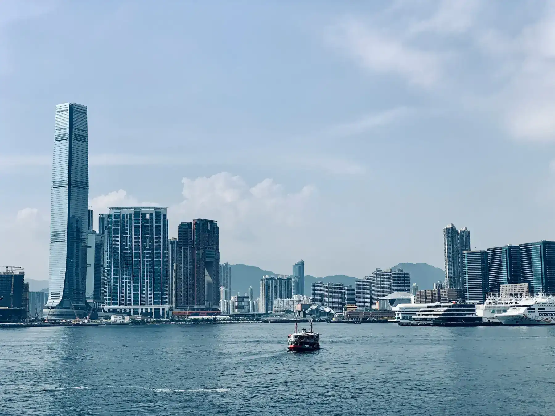 Wan Chai street with tram lines and Hong Kong towers