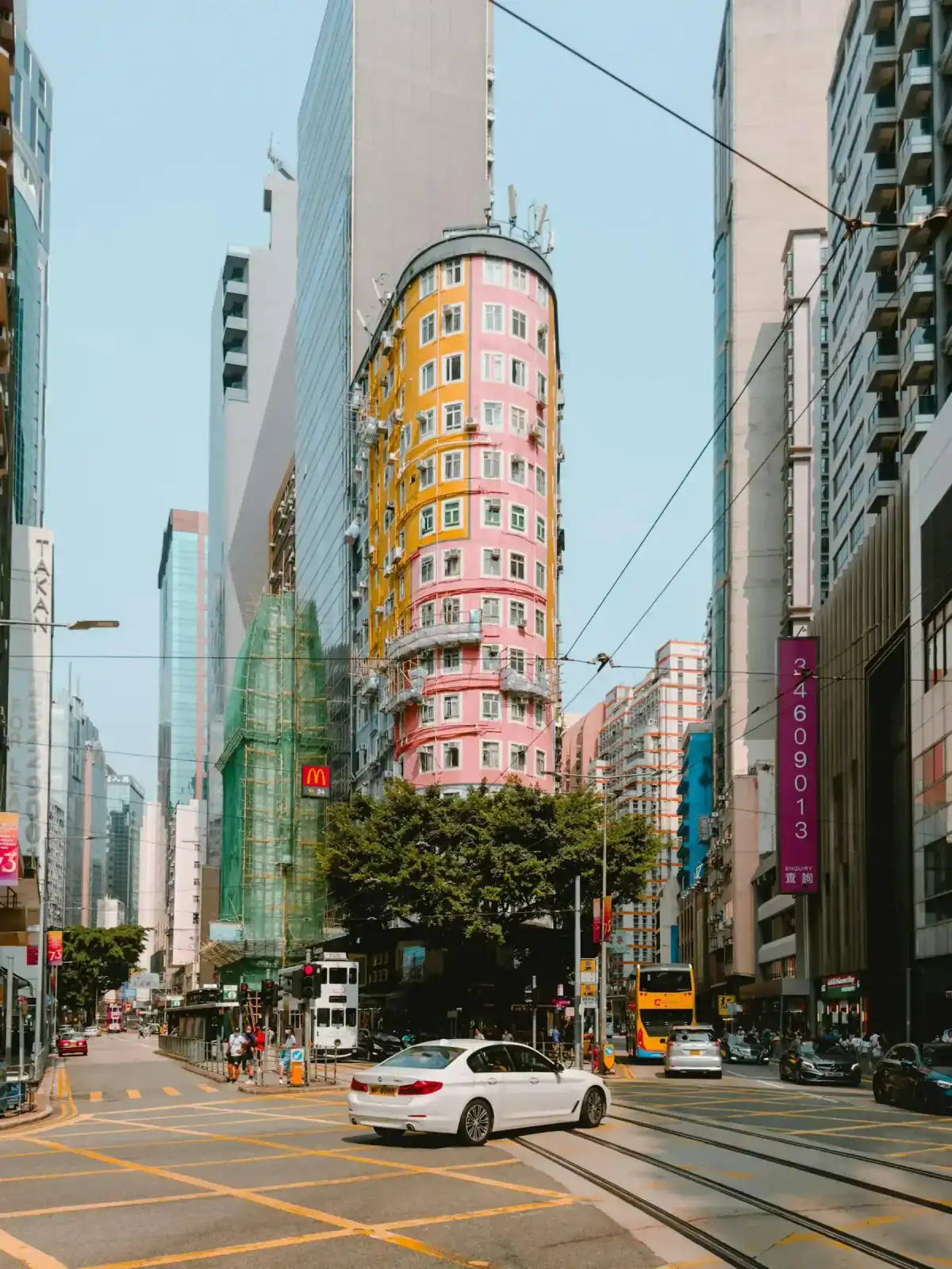 Wan Chai street with tram lines and Hong Kong towers